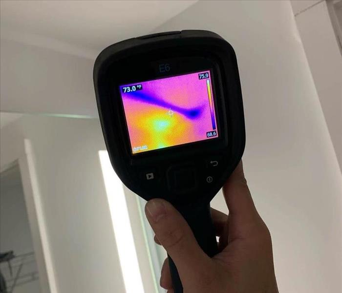 Photo of a thermal moisture meter finding the hidden moisture