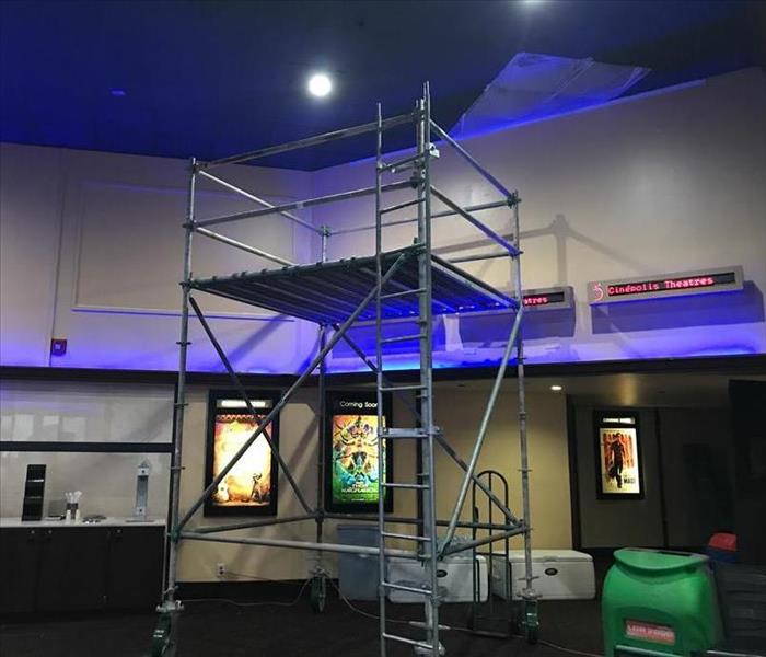 inside of a local theater with scaffolding built inside to remediate mold that had grown in celing