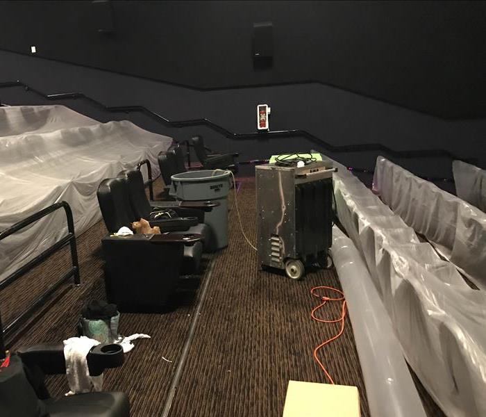 Theater with mold due to water damage has containment set up and drying equipment running